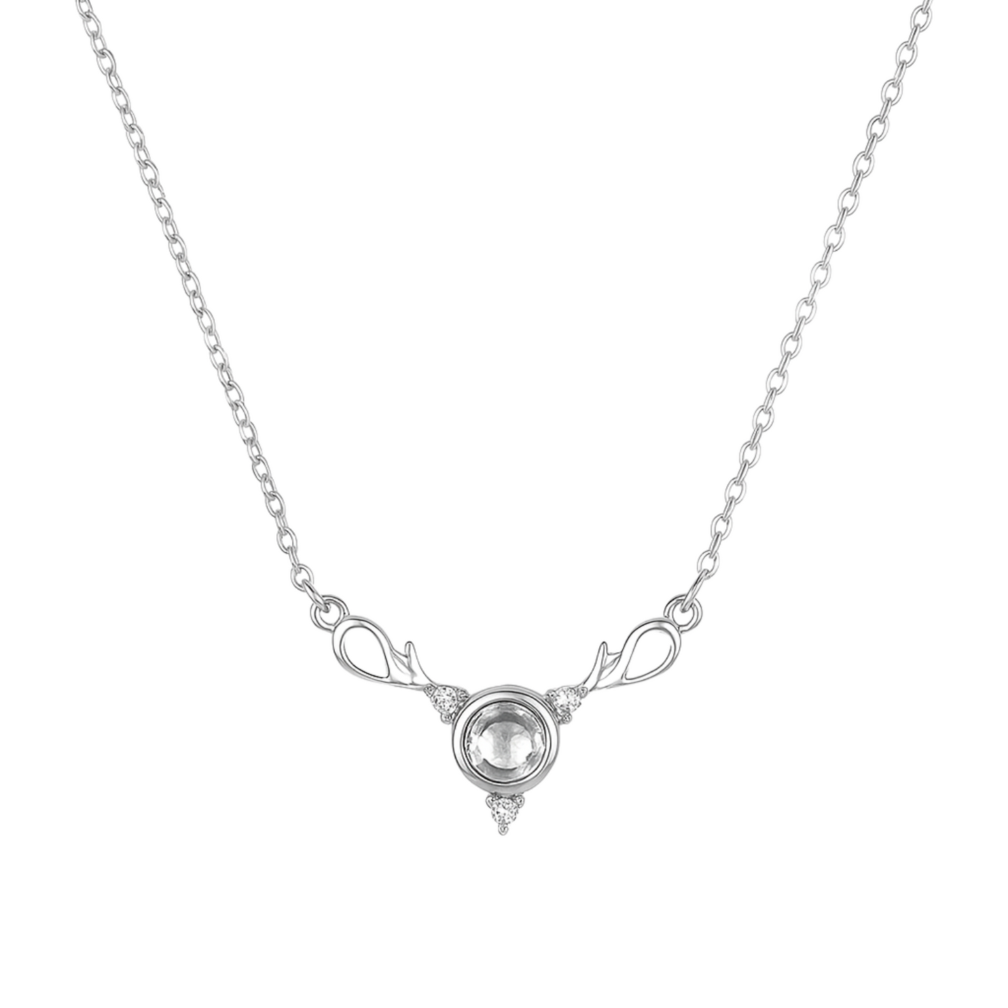 Silver necklace with a clear gemstone on a white background