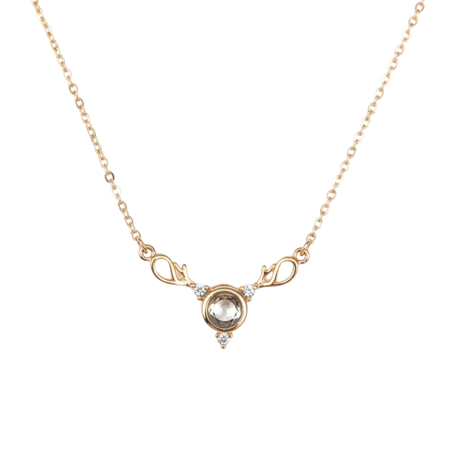 Gold necklace with a central gemstone on a white background