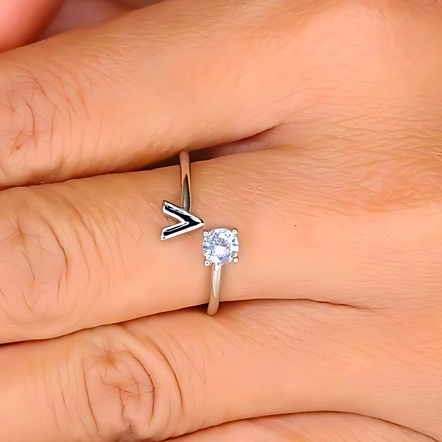 Silver ring with a diamond on a finger