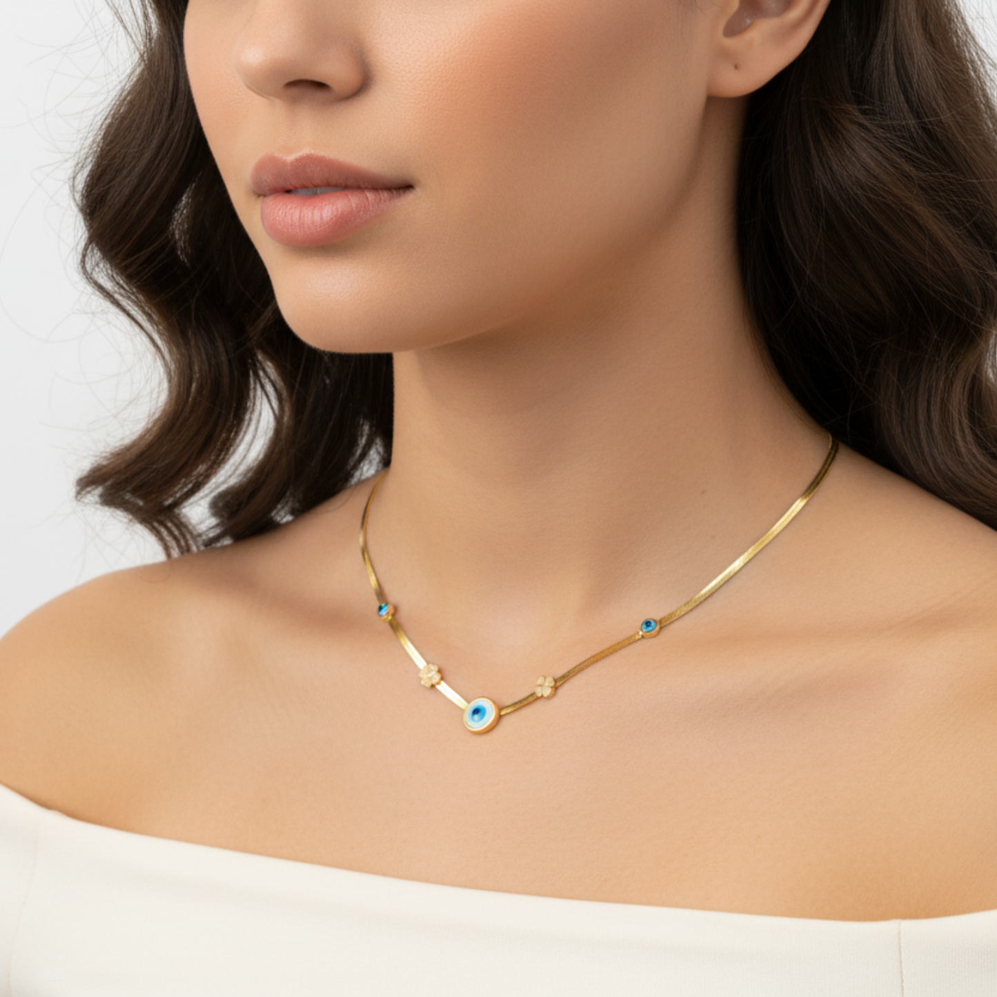 Close-up of a woman wearing a gold necklace with a blue pendant on a white background