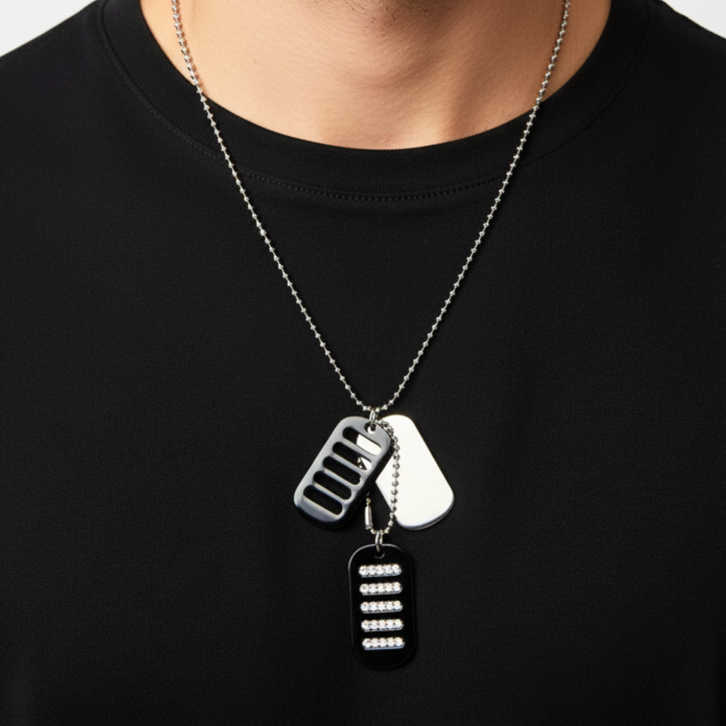 Necklace with three unique pendants on a black shirt background