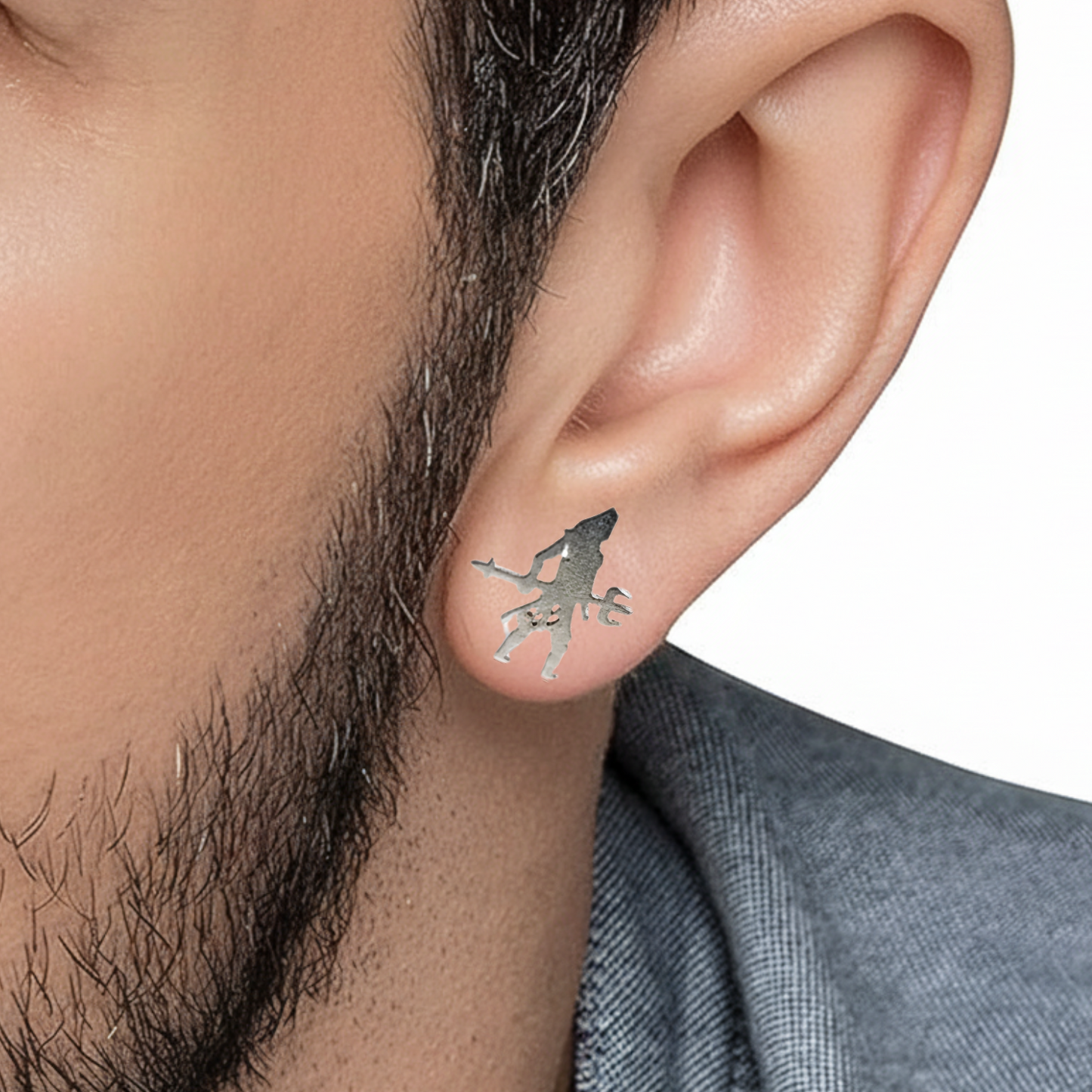 Close-up of an ear wearing a unique earring with a white background