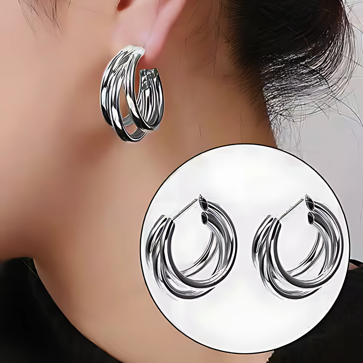 Silver hoop earrings worn by a person, with a close-up inset showing the design.