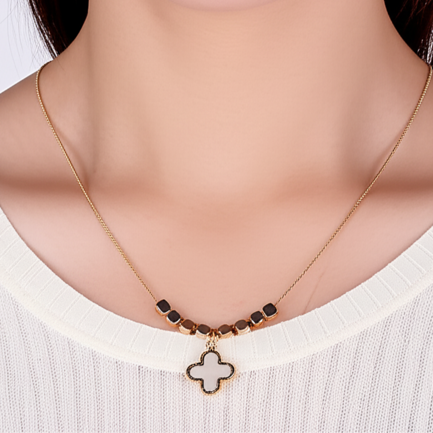 Necklace with a clover pendant on a white background