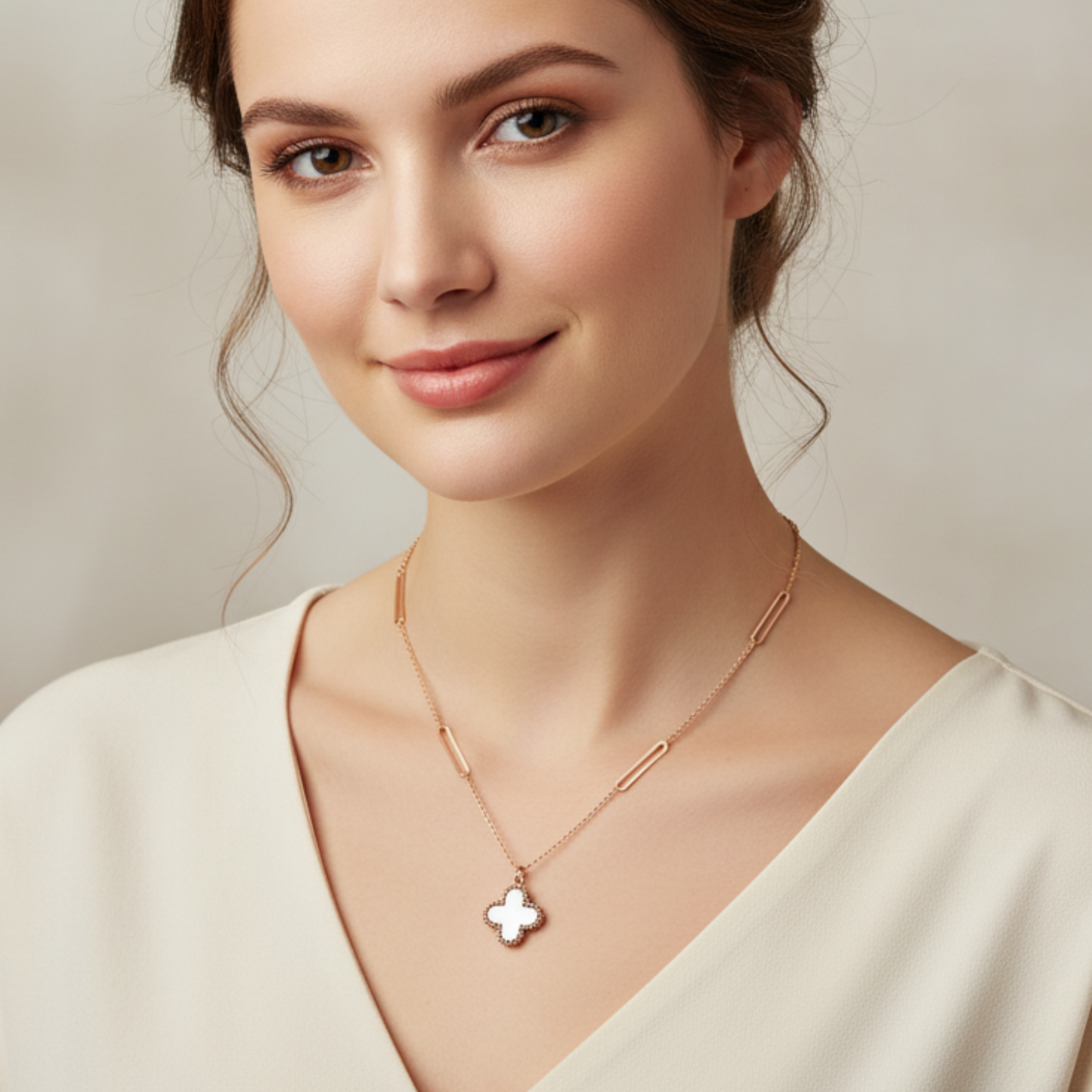Woman wearing a delicate necklace with a butterfly pendant against a neutral background