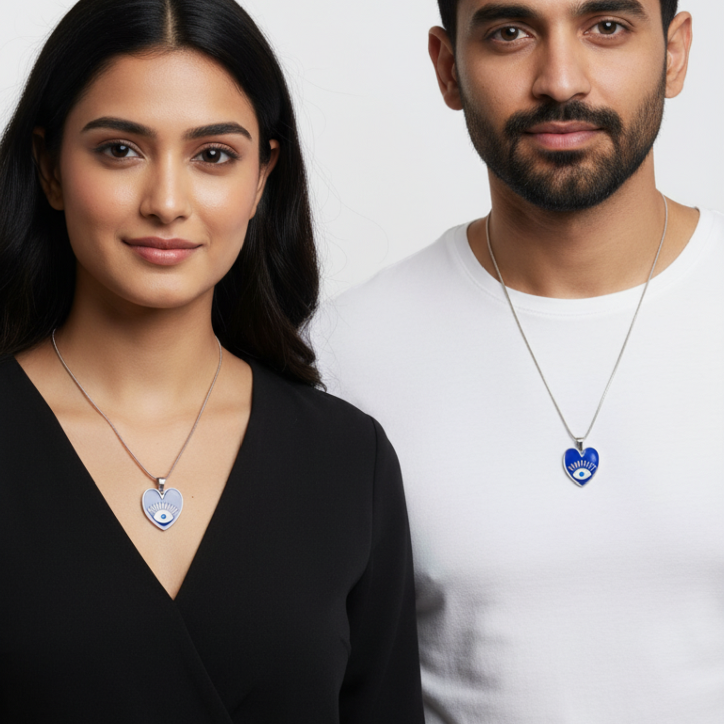 Two people wearing necklaces with heart-shaped pendants against a white background