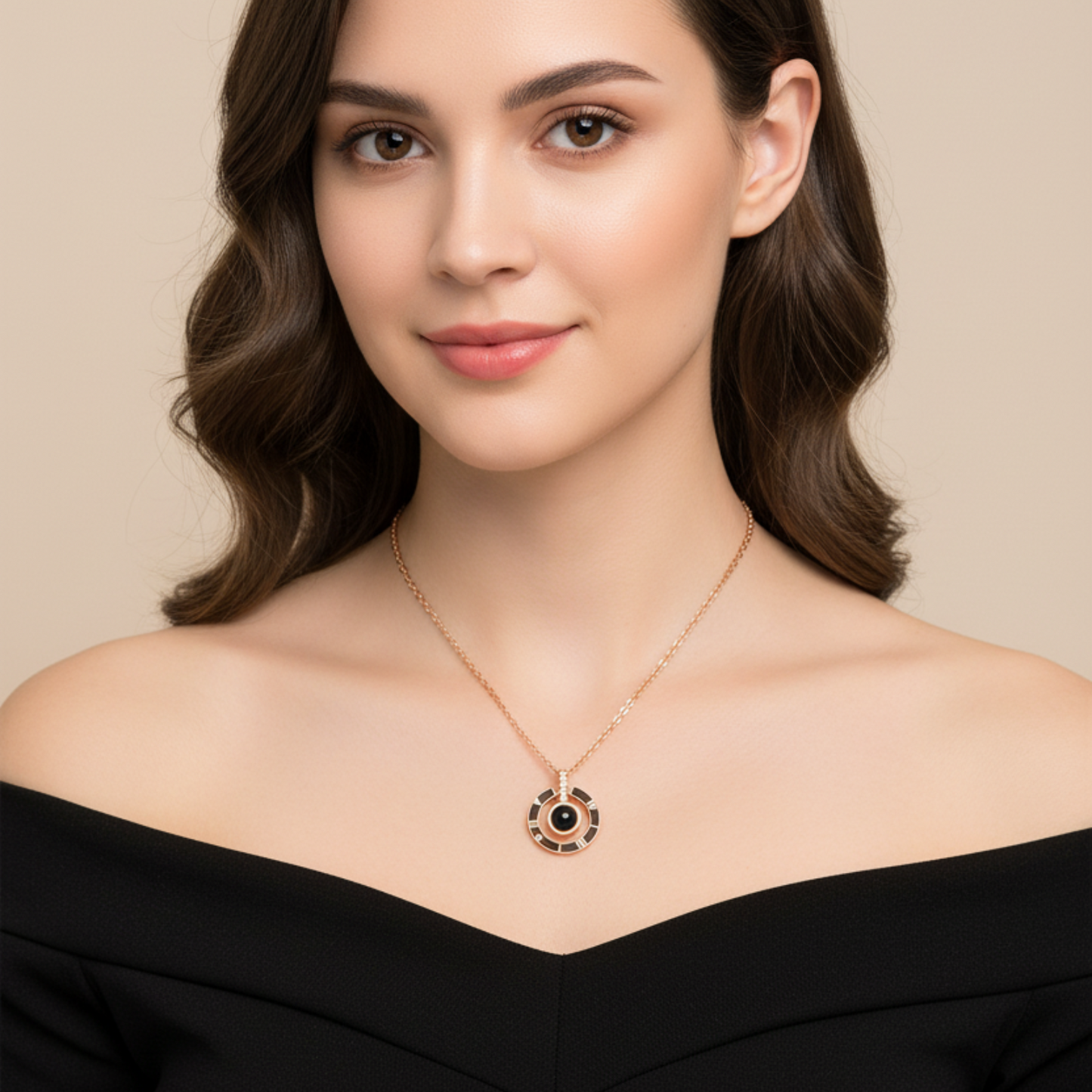 Woman wearing a gold necklace with a black pendant against a beige background