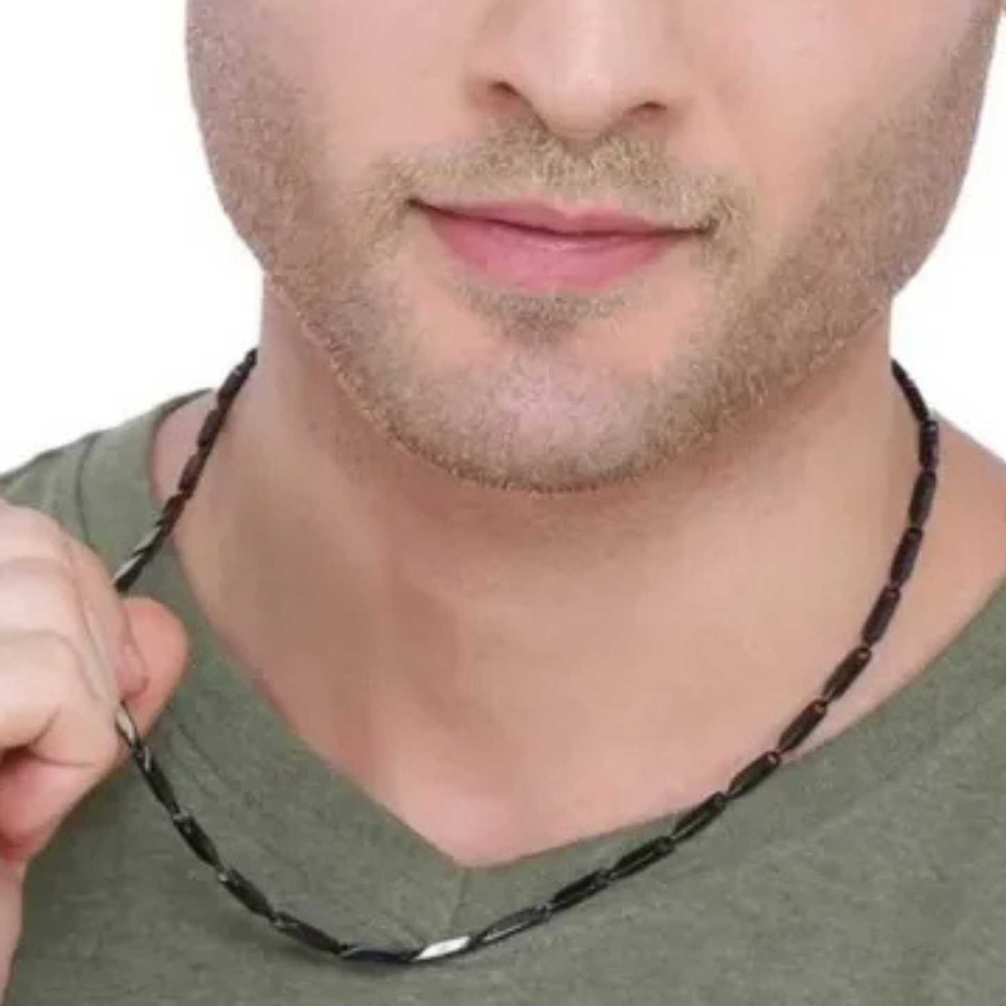 Man wearing a black beaded necklace against a neutral background
