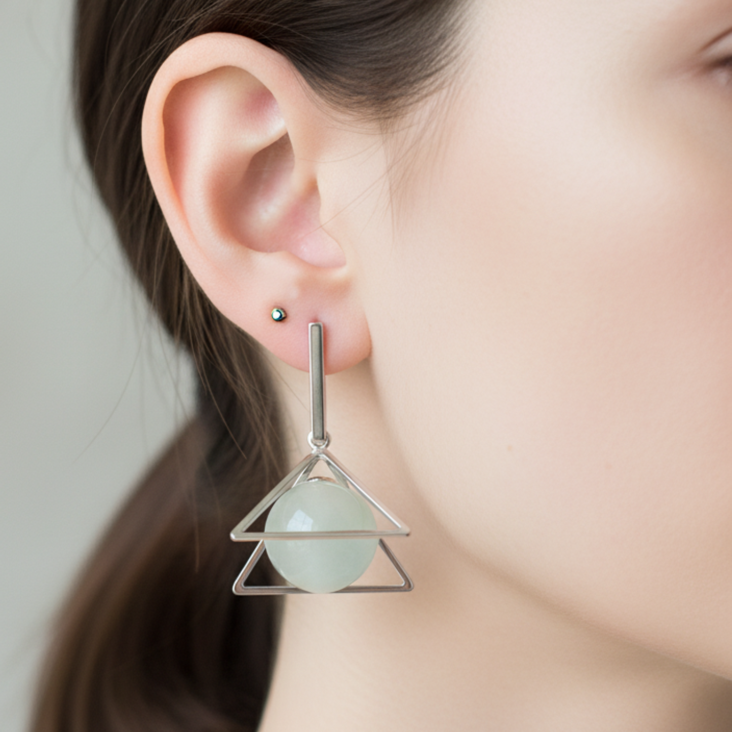 Earring with a geometric design worn by a person
