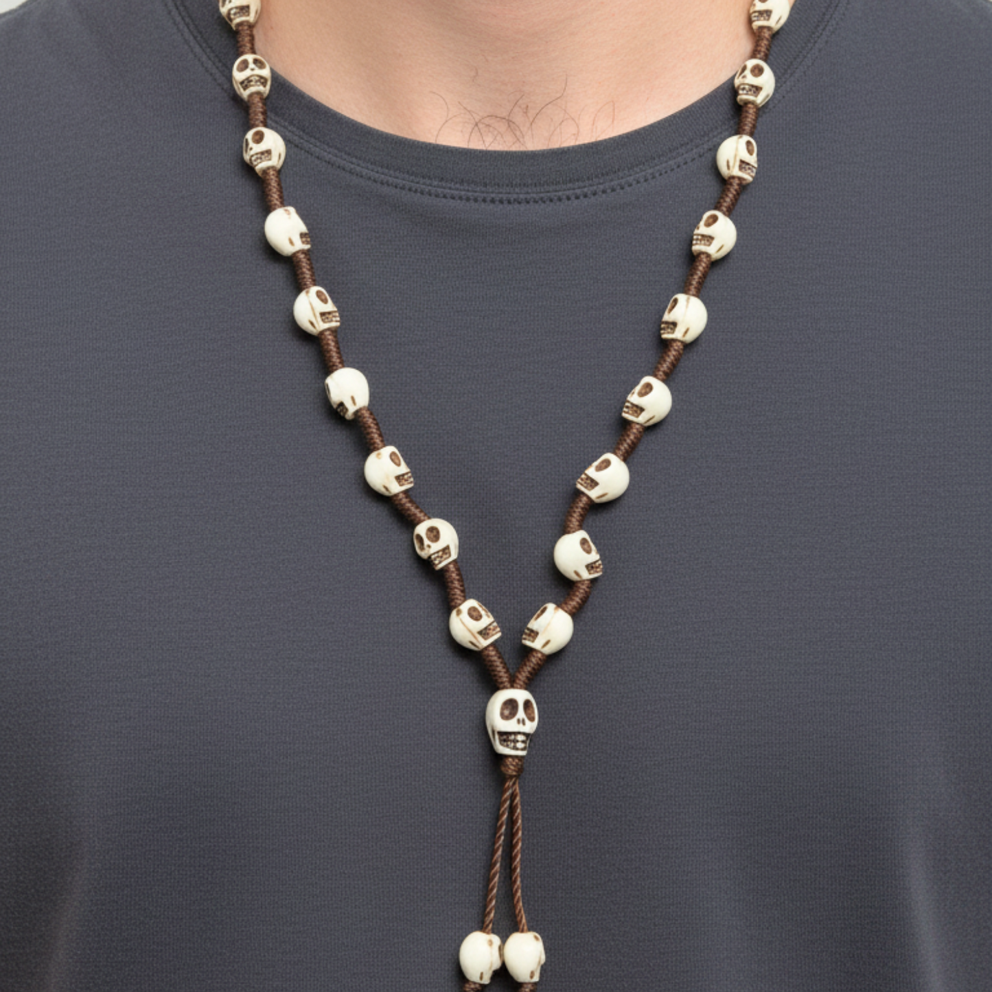 Skull-themed necklace on a person wearing a dark shirt