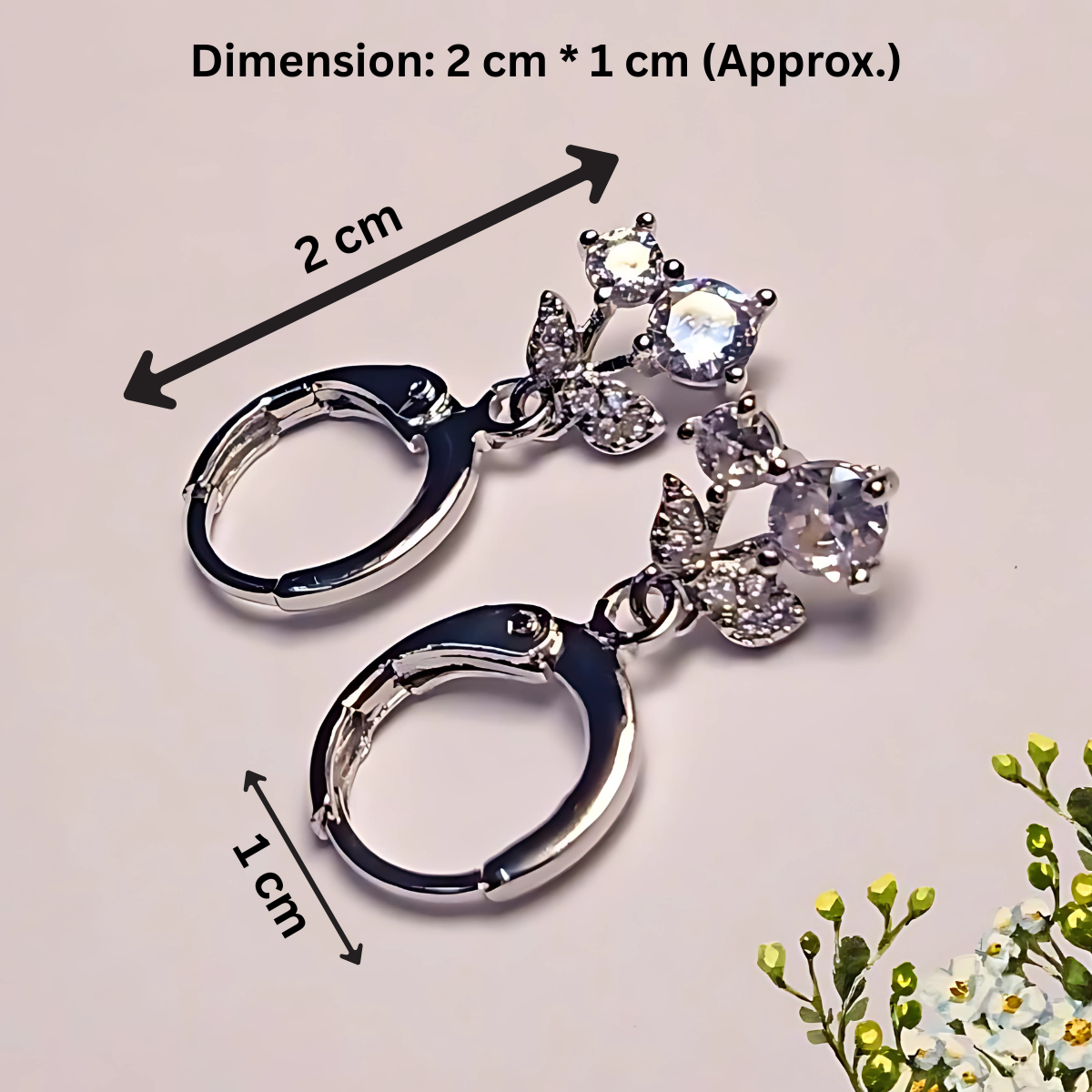 Silver keychain with gemstones and dimensions indicated on a light background