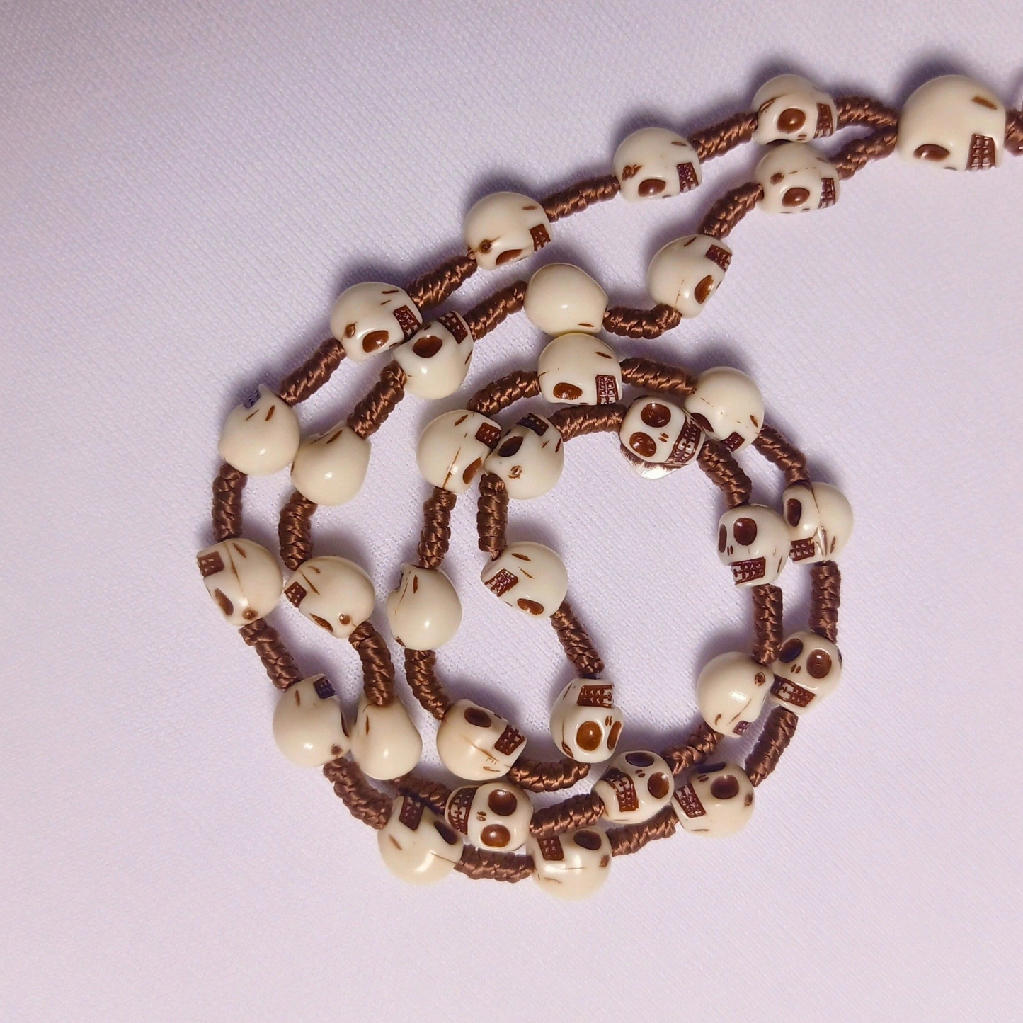 Bracelet with skull-shaped beads on a white background