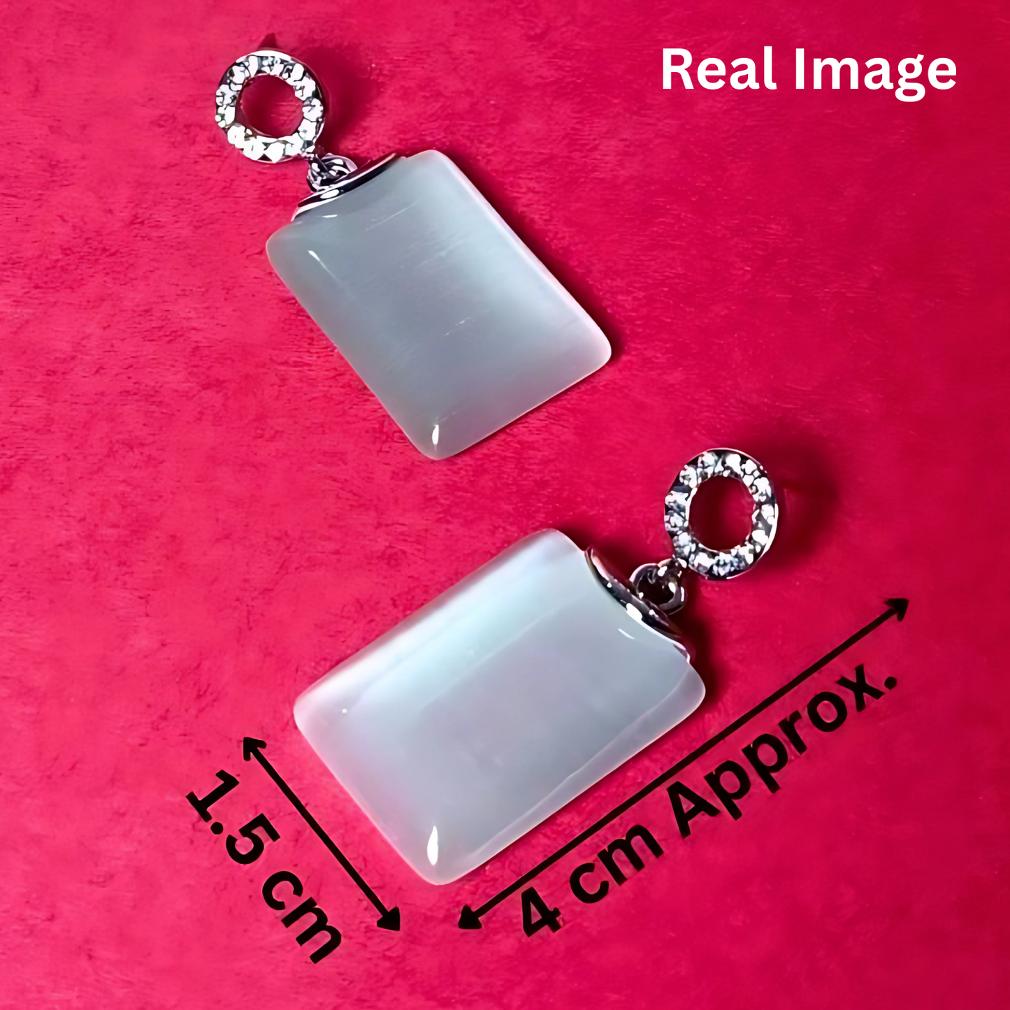 Two white rectangular pendants with silver loops on a pink background, showing measurements.