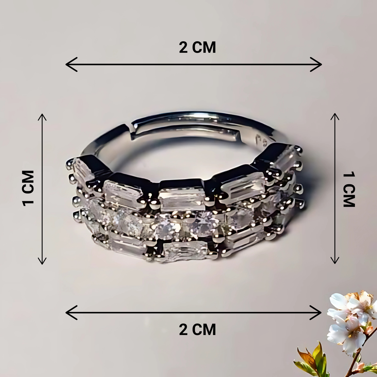 Silver ring with gemstones and measurements on a gray background