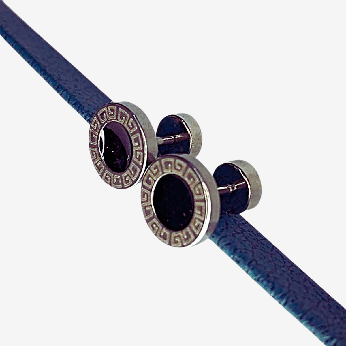 Pair of earring on a blue cord against a white background