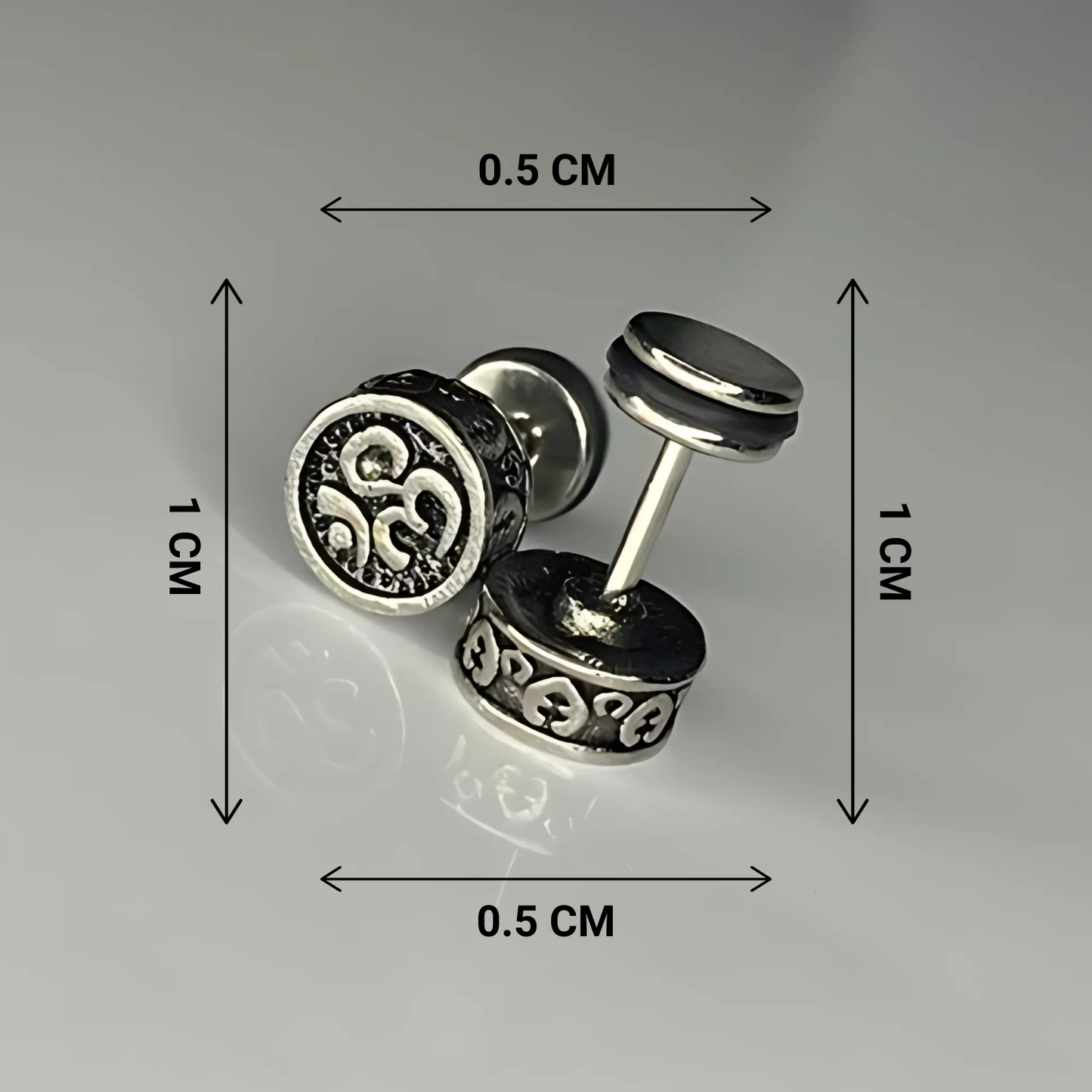 Silver stud earrings with measurements on a gray background