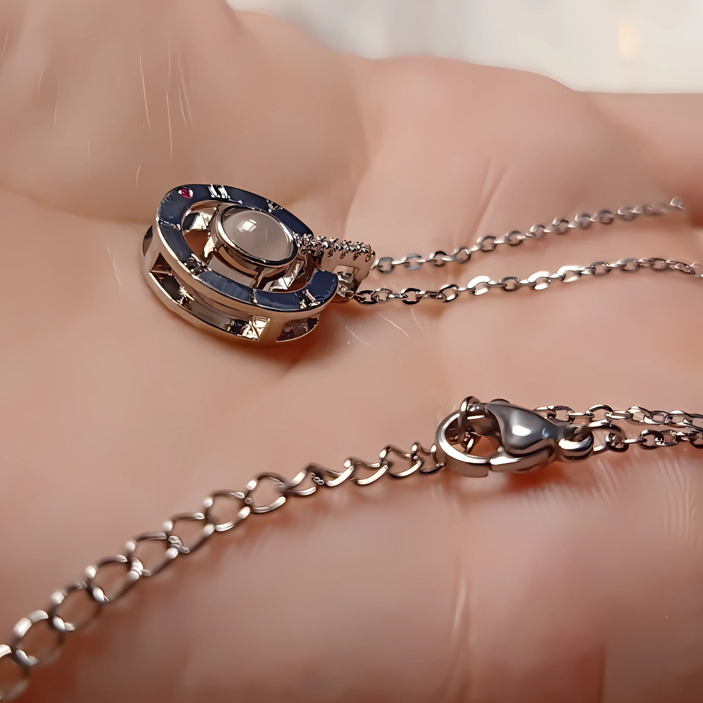 Silver necklace with a pendant on a hand