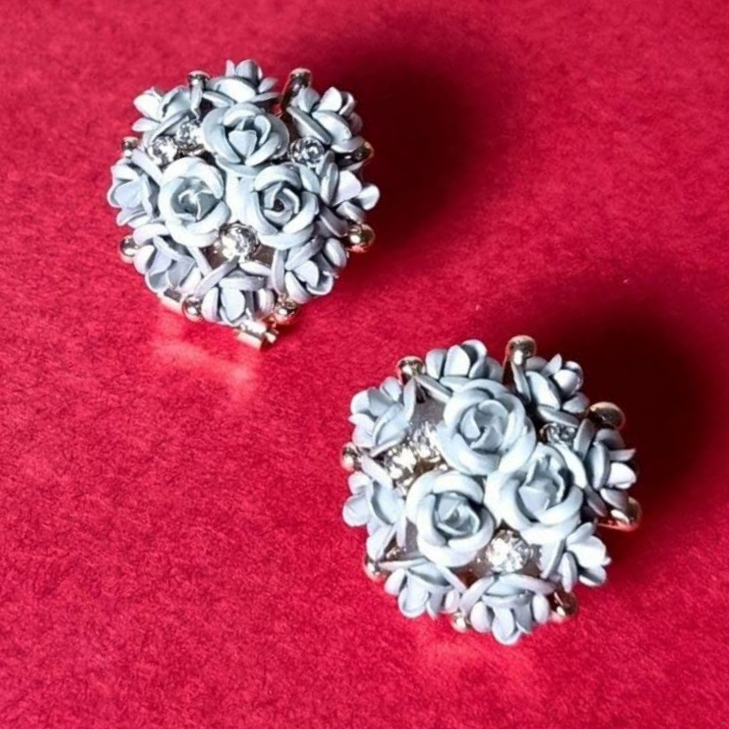 Pair of floral earrings on a red background