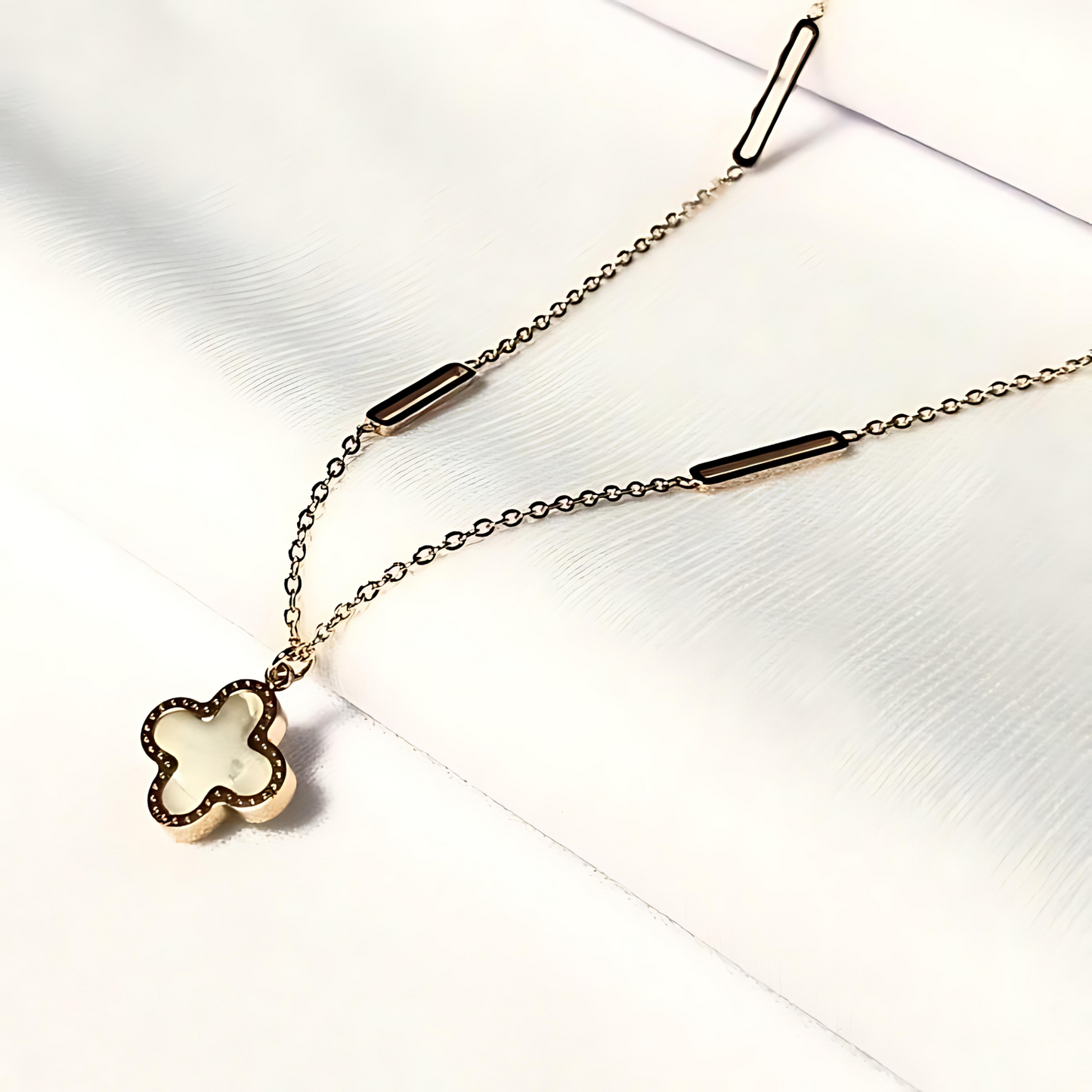 Necklace with a clover-shaped pendant on a white background
