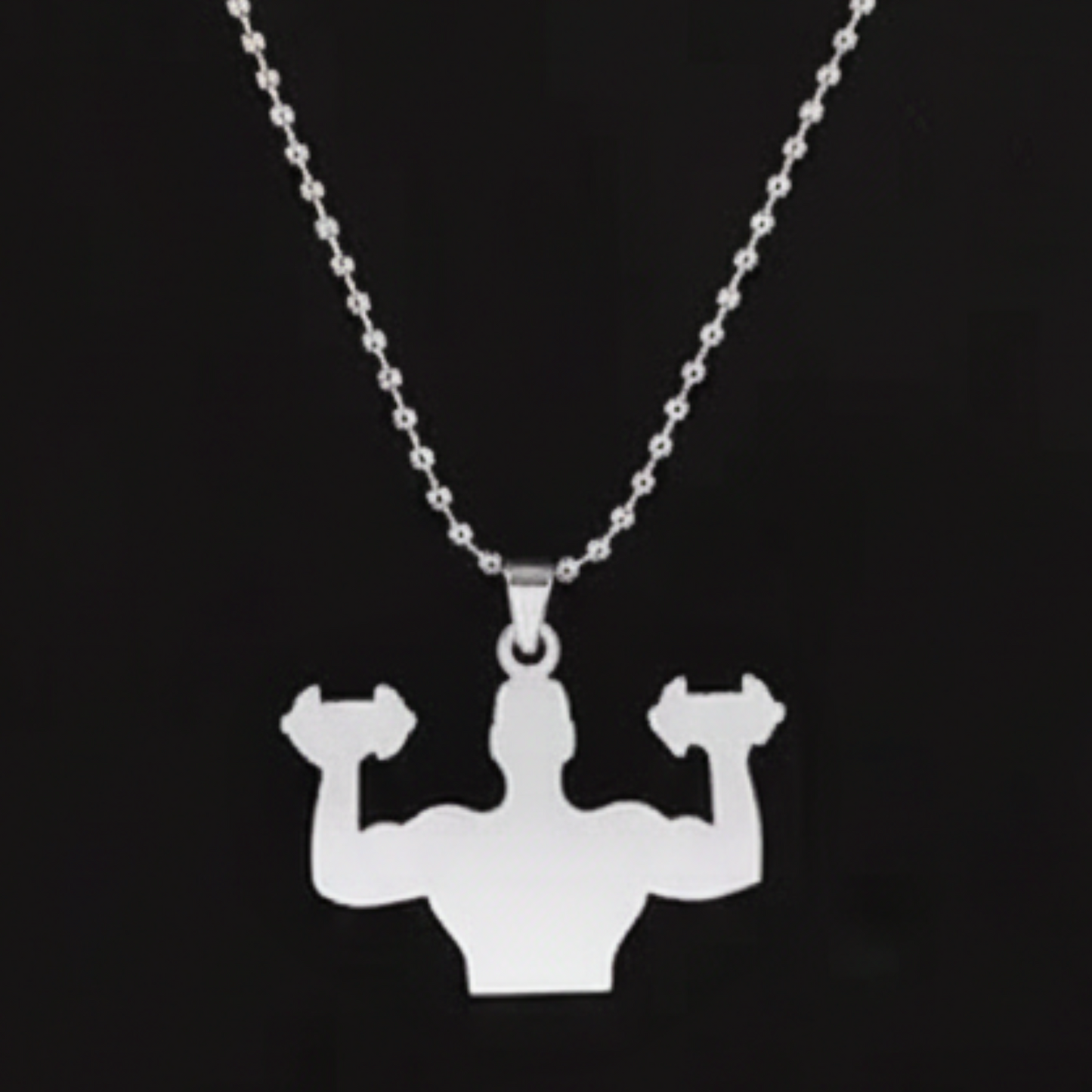 Silver necklace with a pendant of a muscular figure lifting weights on a black background