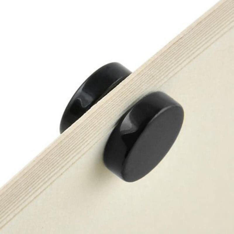 Black cabinet knob on a wooden drawer