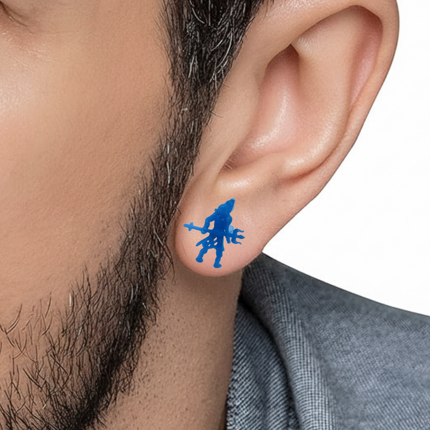 Blue shiva stud on a person's ear with a white background