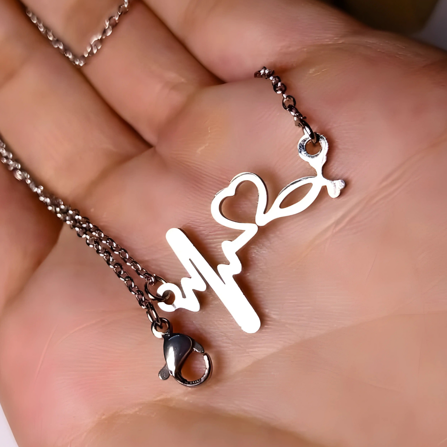 Necklace with a unique pendant held in a hand