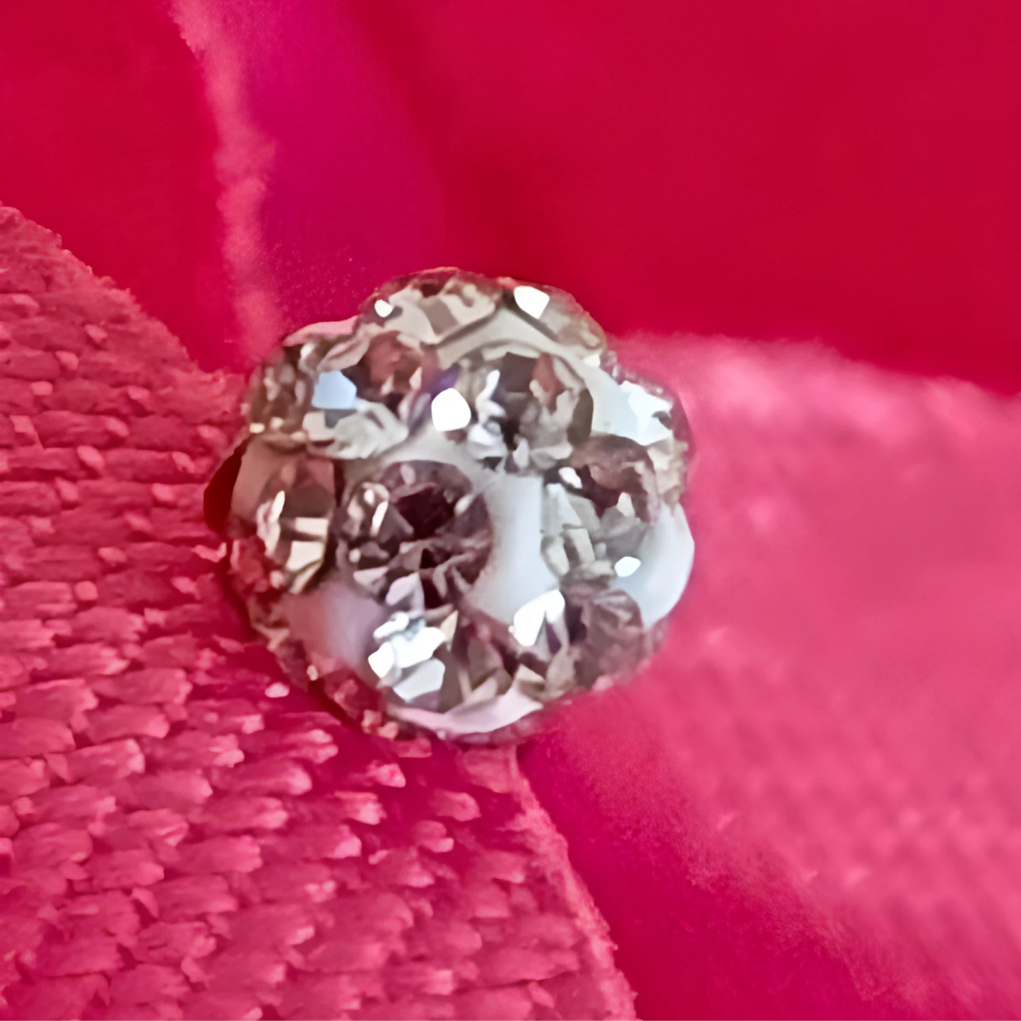 Close-up of a diamond on a red fabric background