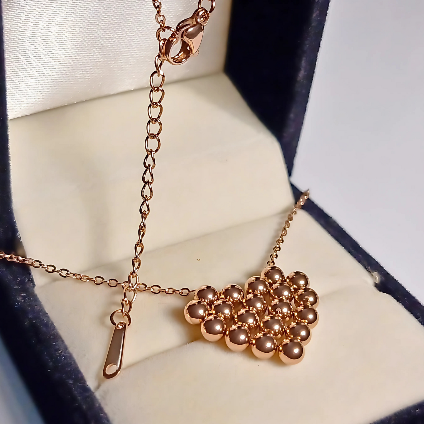 Rose gold necklace with a cluster pendant in a box