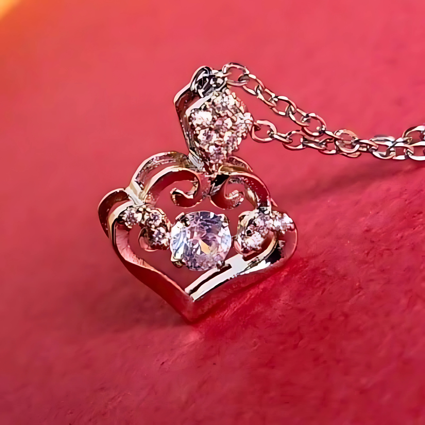 Heart-shaped pendant with a chain on a red background