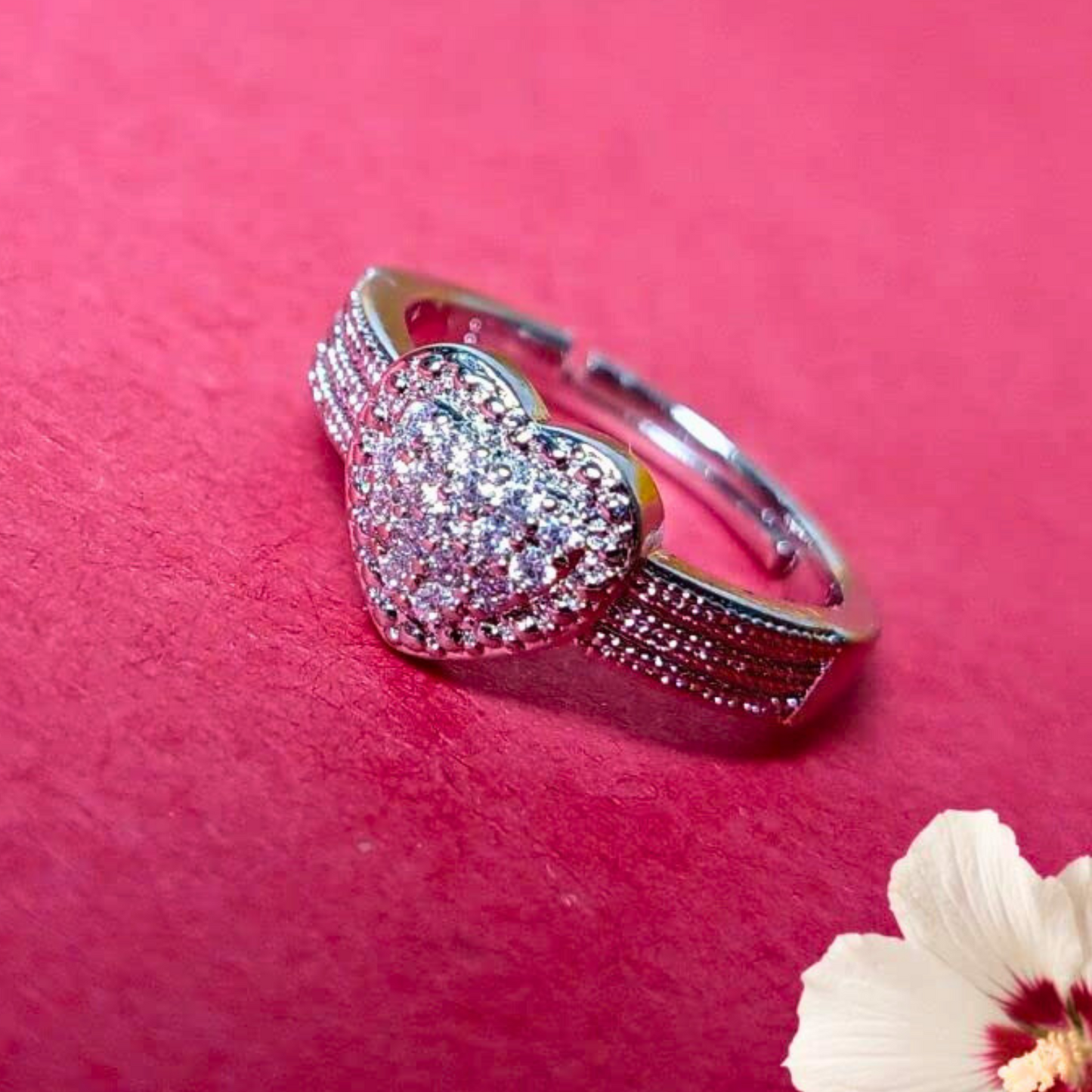 Heart-shaped bracelet with sparkling stones on a pink background