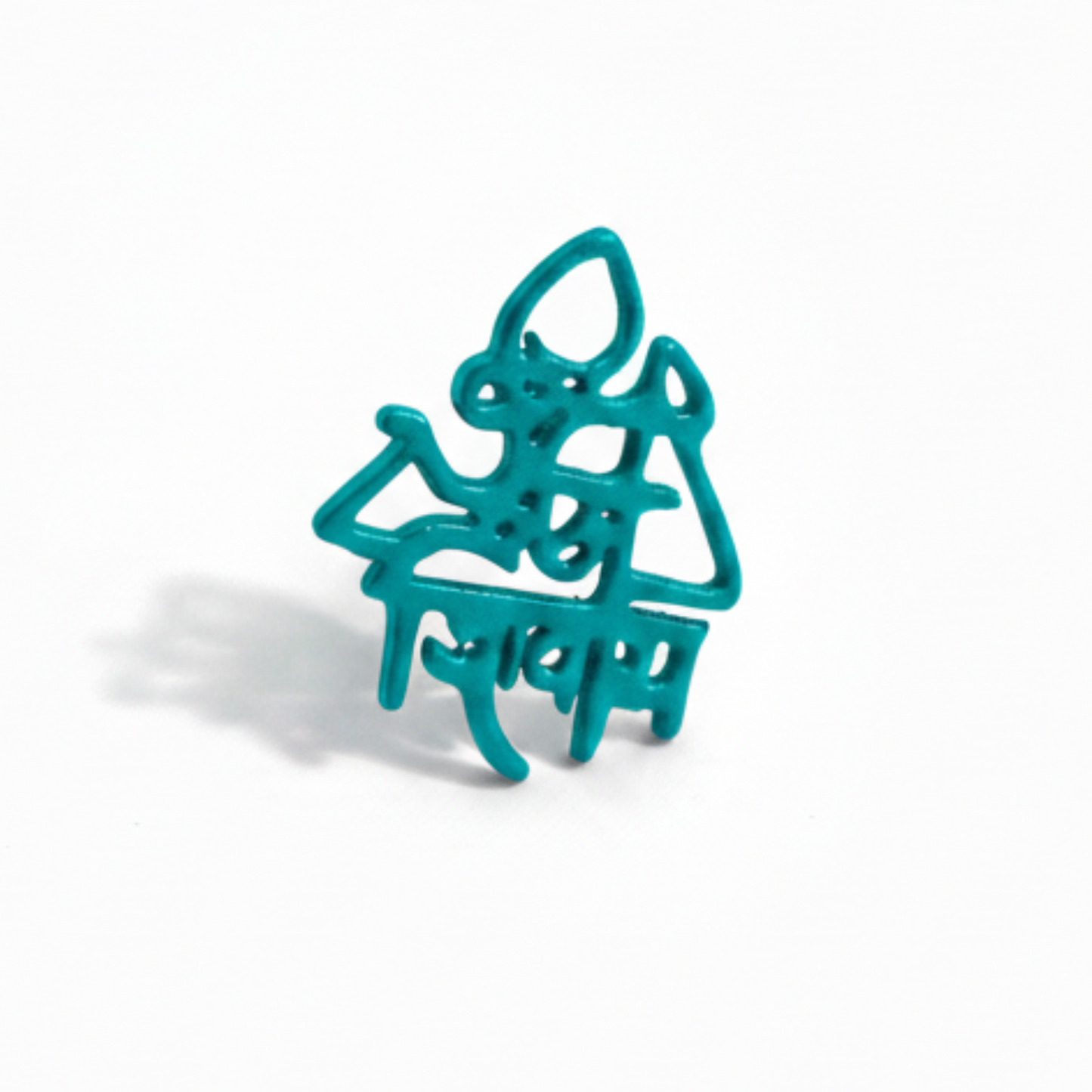 Turquoise metal spider-shaped object on a white background