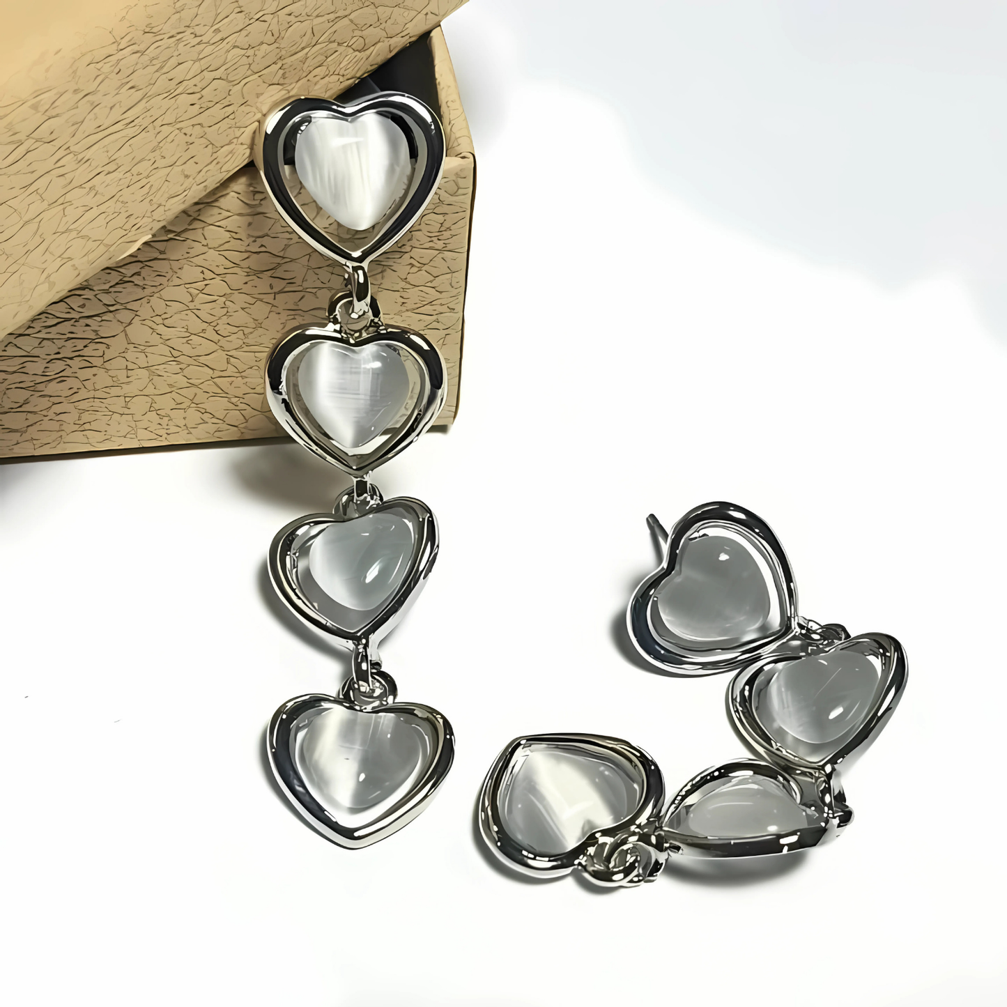 Silver heart-shaped earrings on a white background