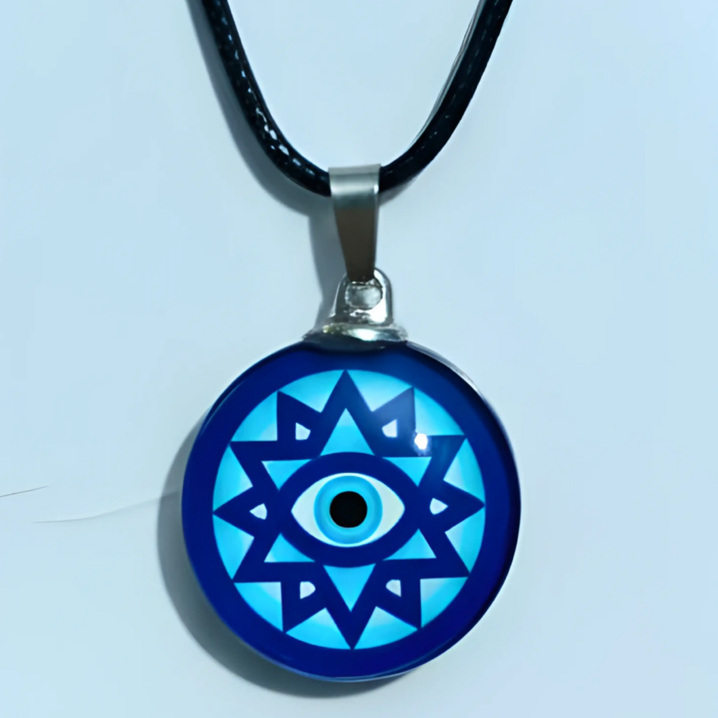 Necklace with a blue and black pendant featuring an eye design on a light blue background