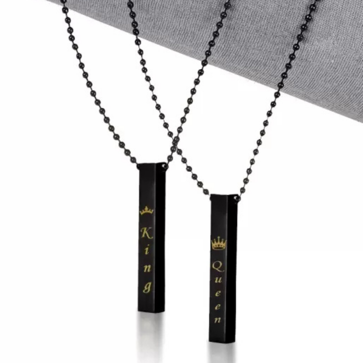 Two black cylindrical pendants with 'King' and 'Queen' text on a white background