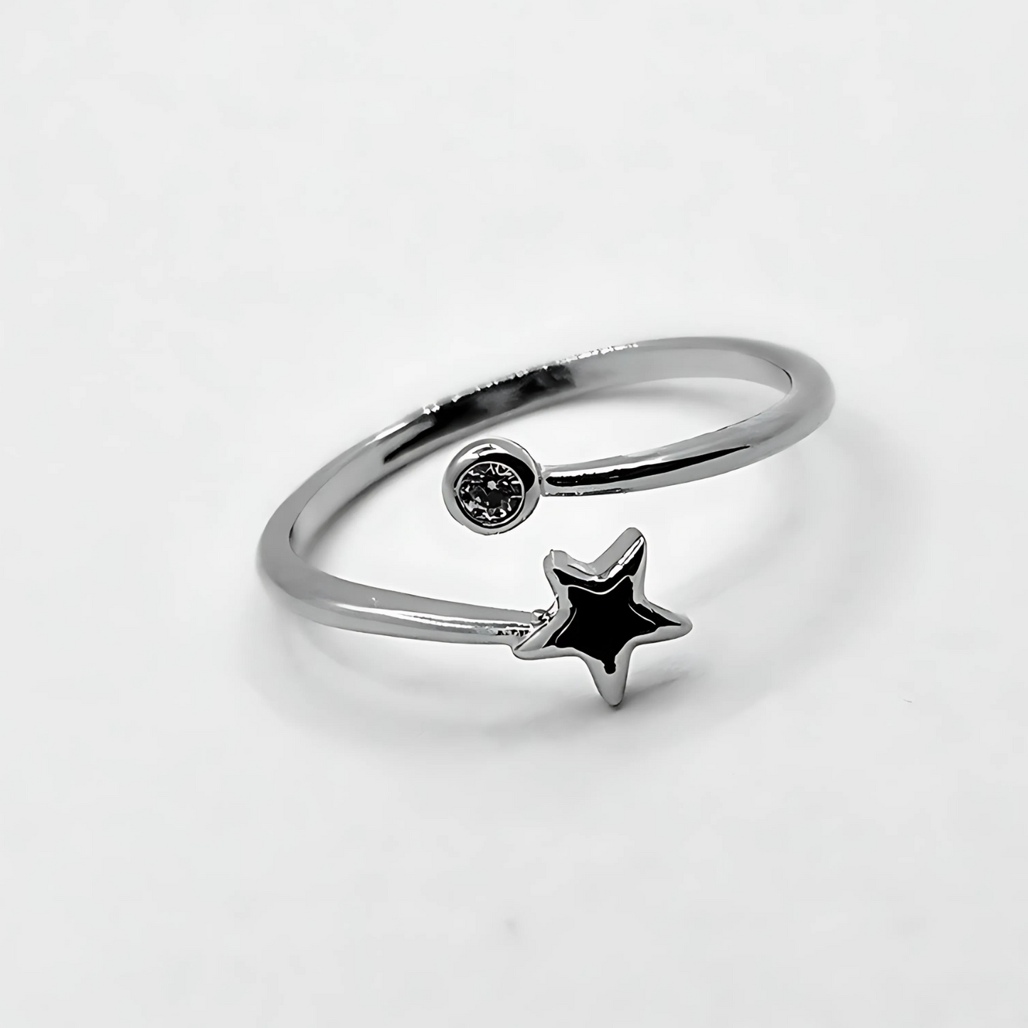 Silver ring with a star-shaped gem on a light gray background
