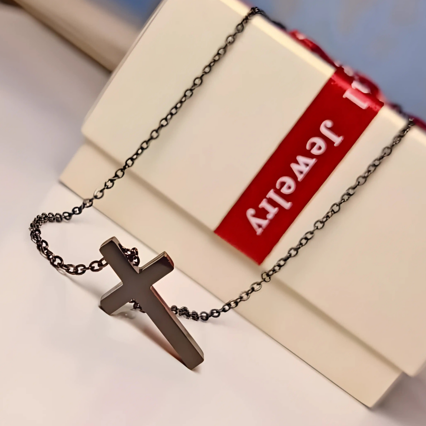 Cross necklace on a jewelry box with 'Jewelry' label