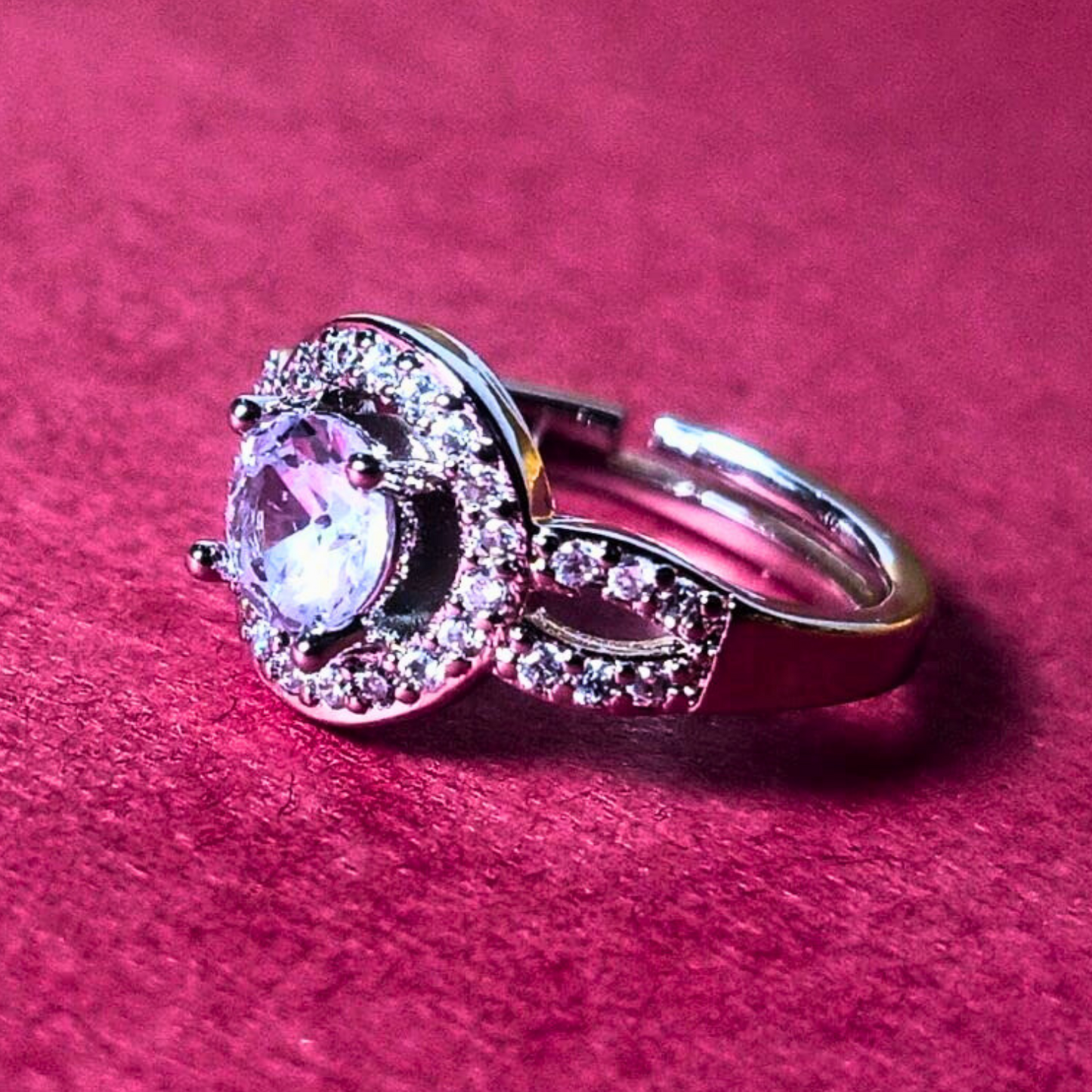 Silver ring with a gemstone on a pink background