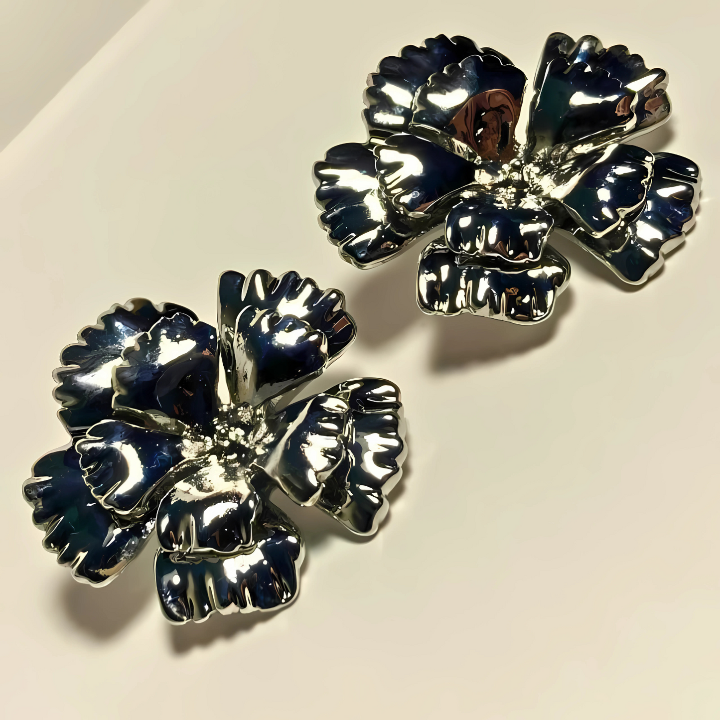 Pair of silver floral earrings on a light background