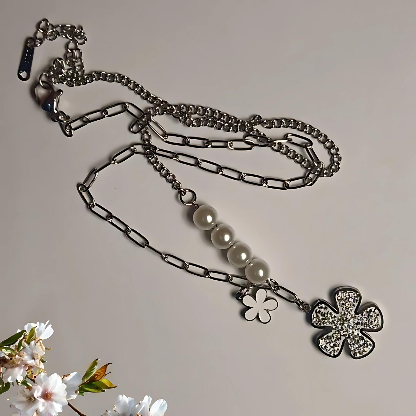 Necklace with floral pendants on a neutral background