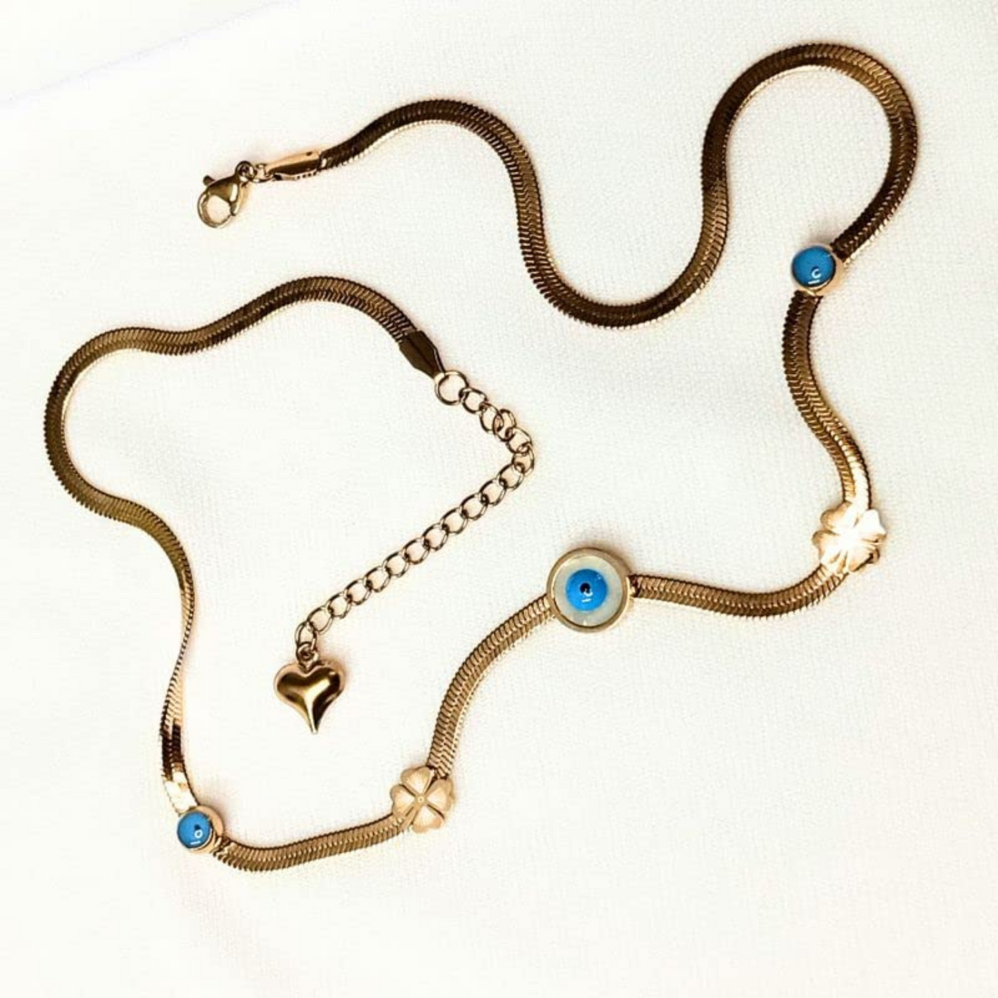 Gold necklace with blue gemstones on a white background