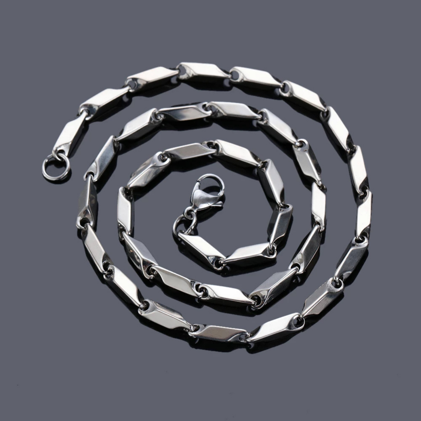 Silver chain necklace on a dark gray background