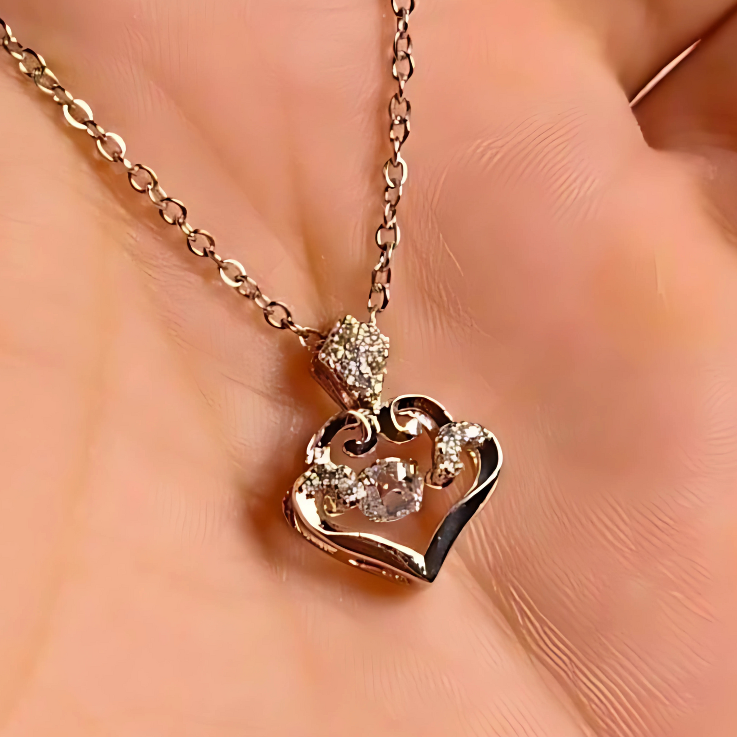 Rose gold heart-shaped necklace with diamond accents on a soft peach background