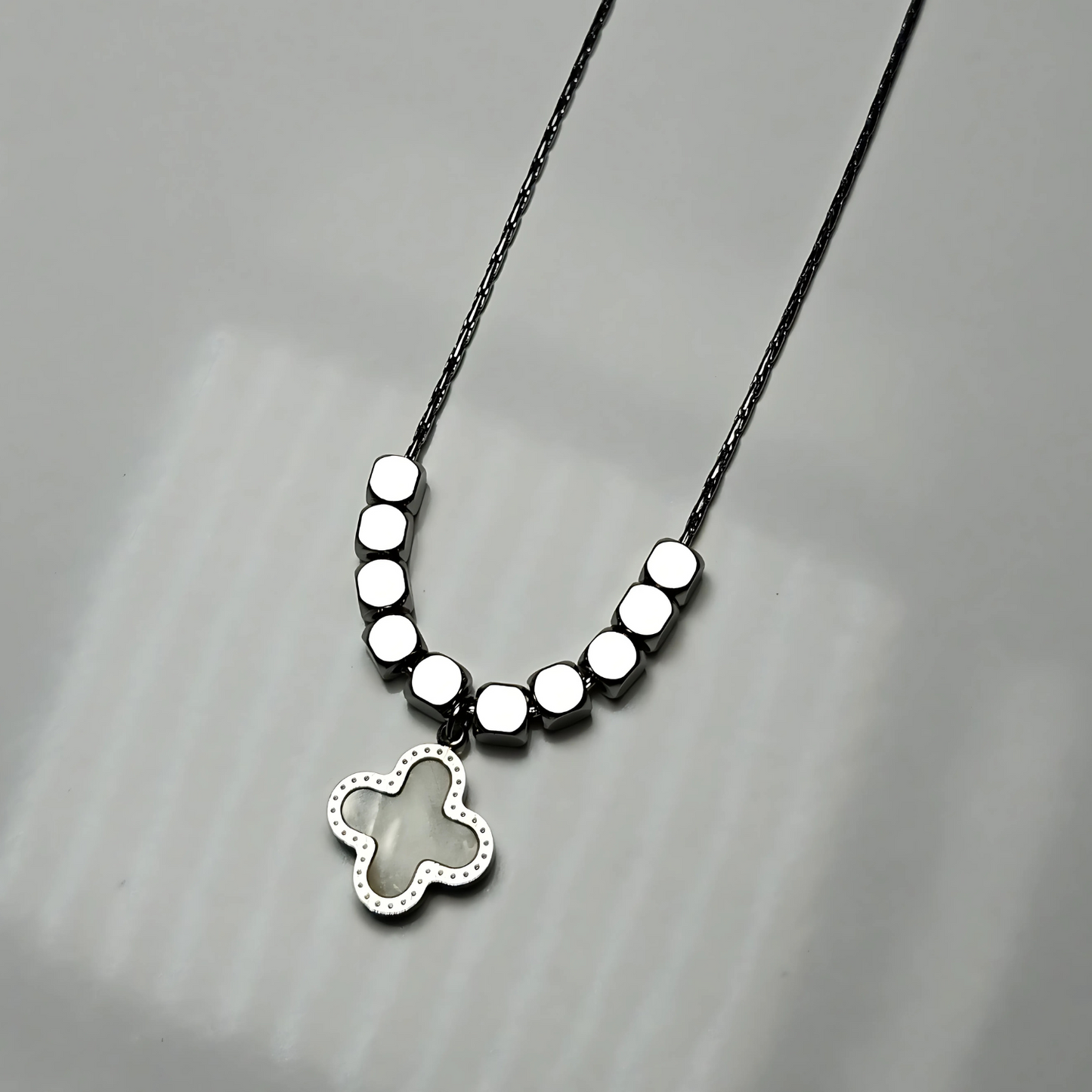 Necklace with a butterfly pendant on a gray background