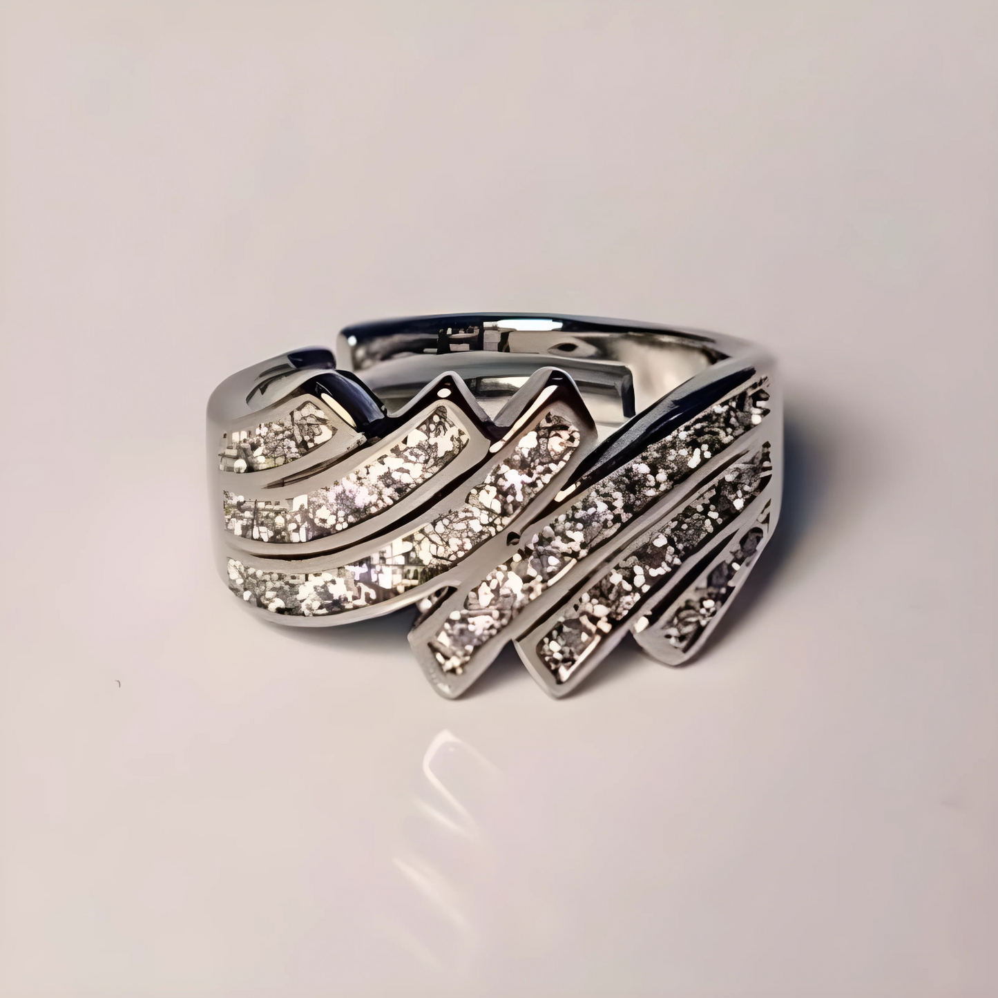 Silver ring with diamond accents on a light gray background