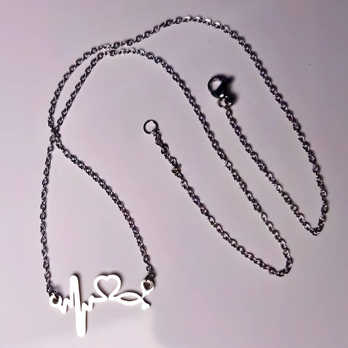 Necklace with a heart-shaped pendant on a light gray background