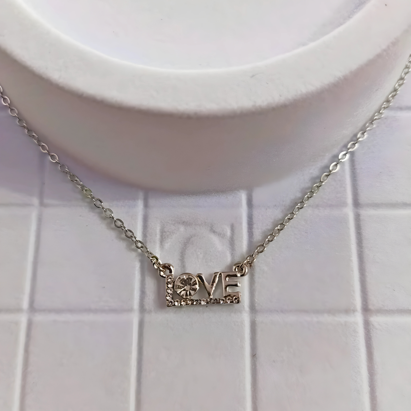 Necklace with a 'LOVE' pendant on a white background