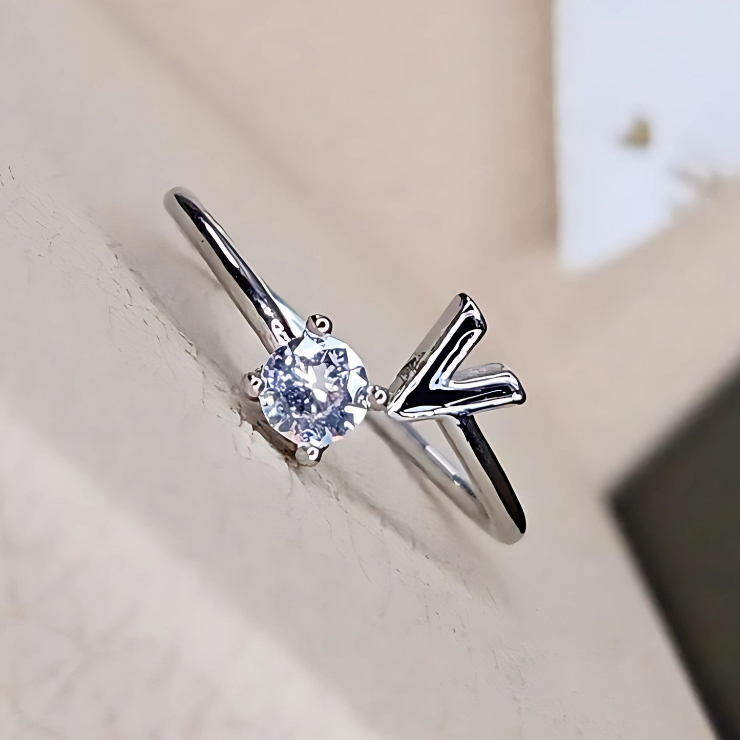 Silver ring with a diamond on a light background