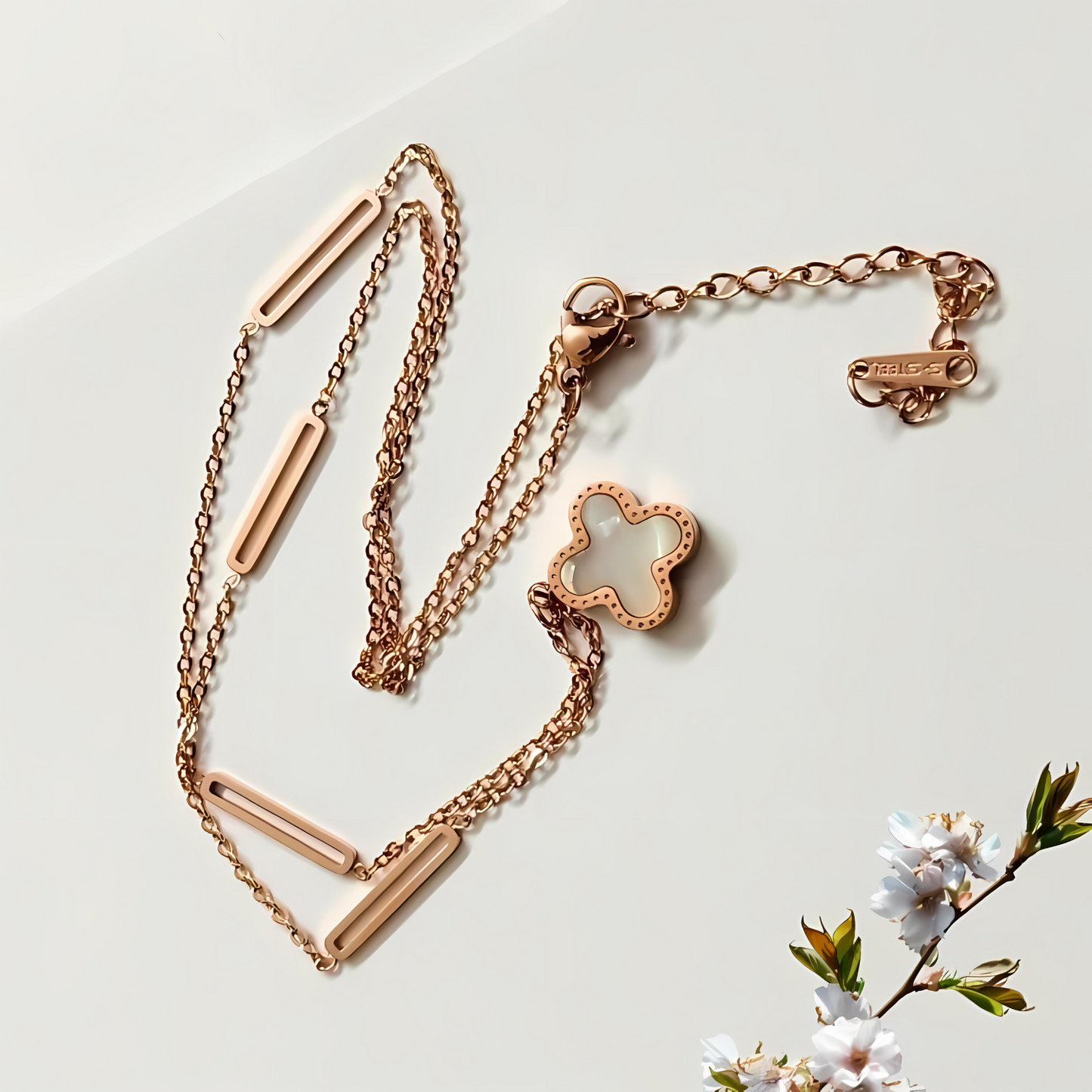 Rose gold necklace with lobster clasp on a light background