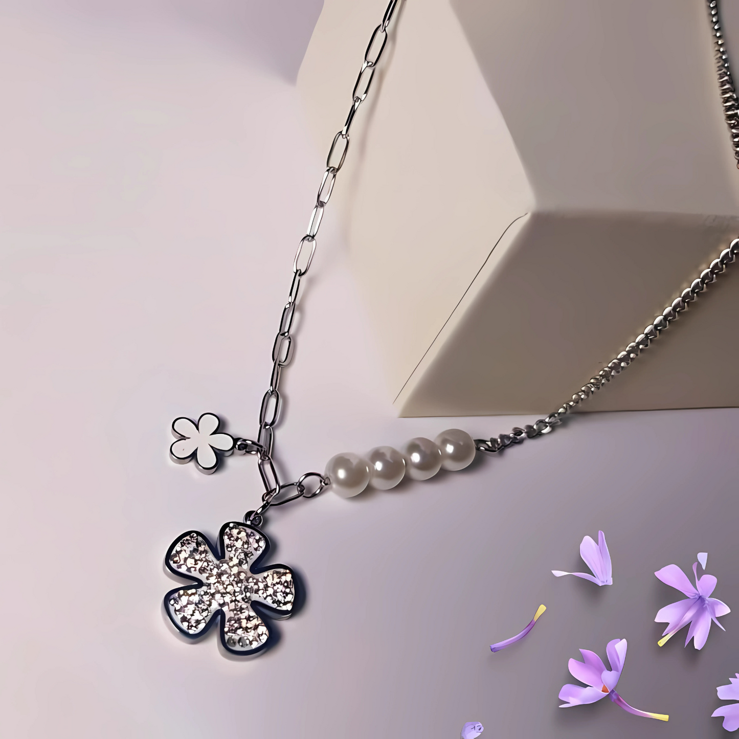 Necklace with floral pendants and pearls on a light background